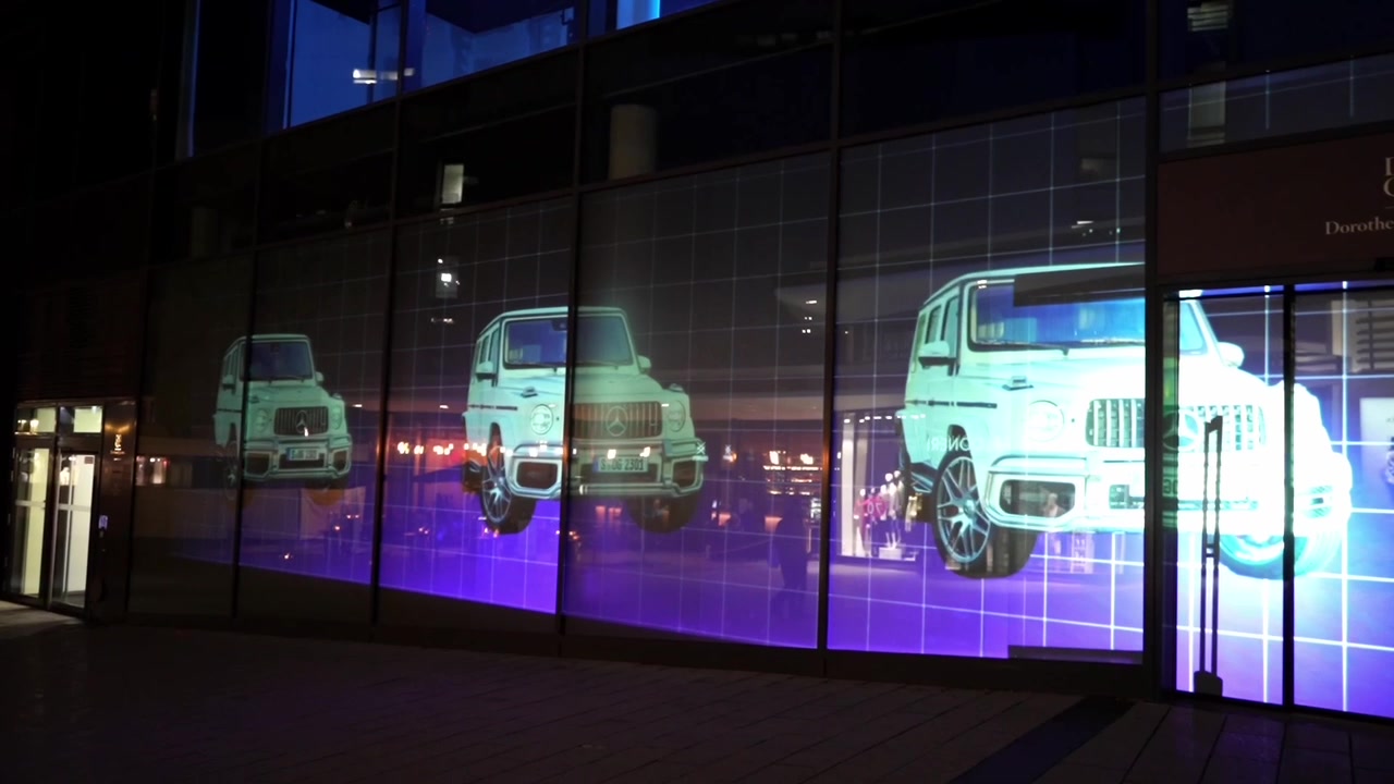 Digital artworks projected onto Doro Quartier at night